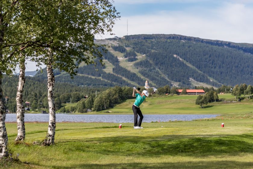 Kvinna gör en swing med en golfklubba